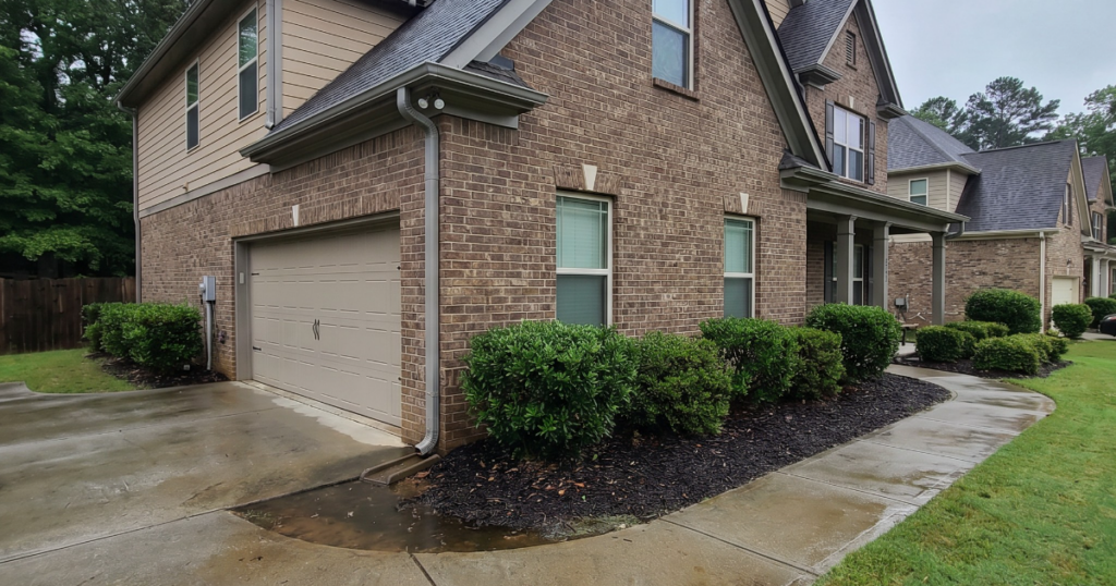 Georgia home exterior after rain with visible roofline, gutters, wet driveway, and damp siding for storm documentation tips.