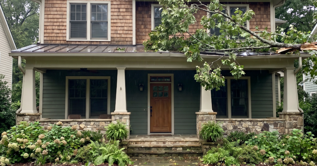 Upscale Georgia craftsman-style home after a fallen tree limb reached the porch roof and gutter for property insurance documentation.