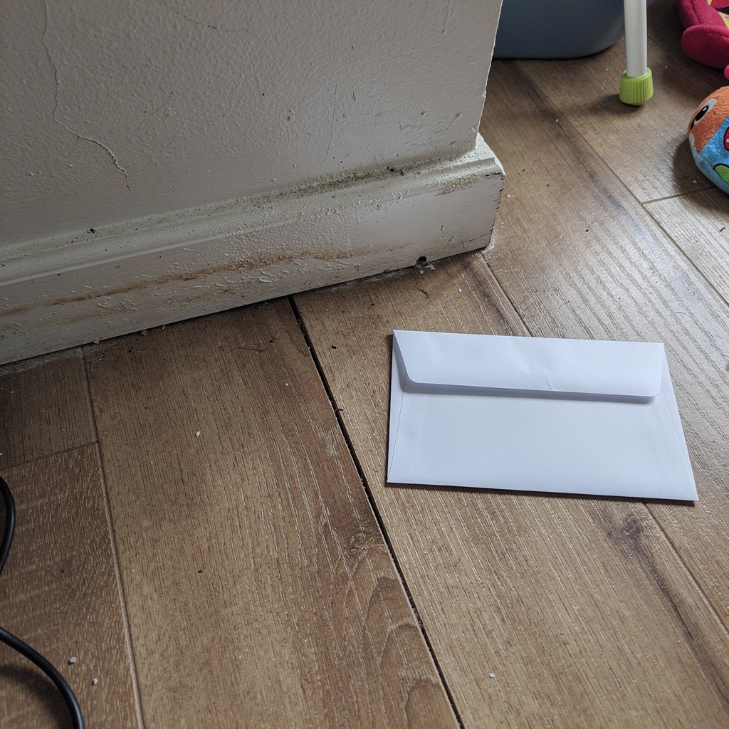 Denial letter and property damage photos saved for claim review before repairs
