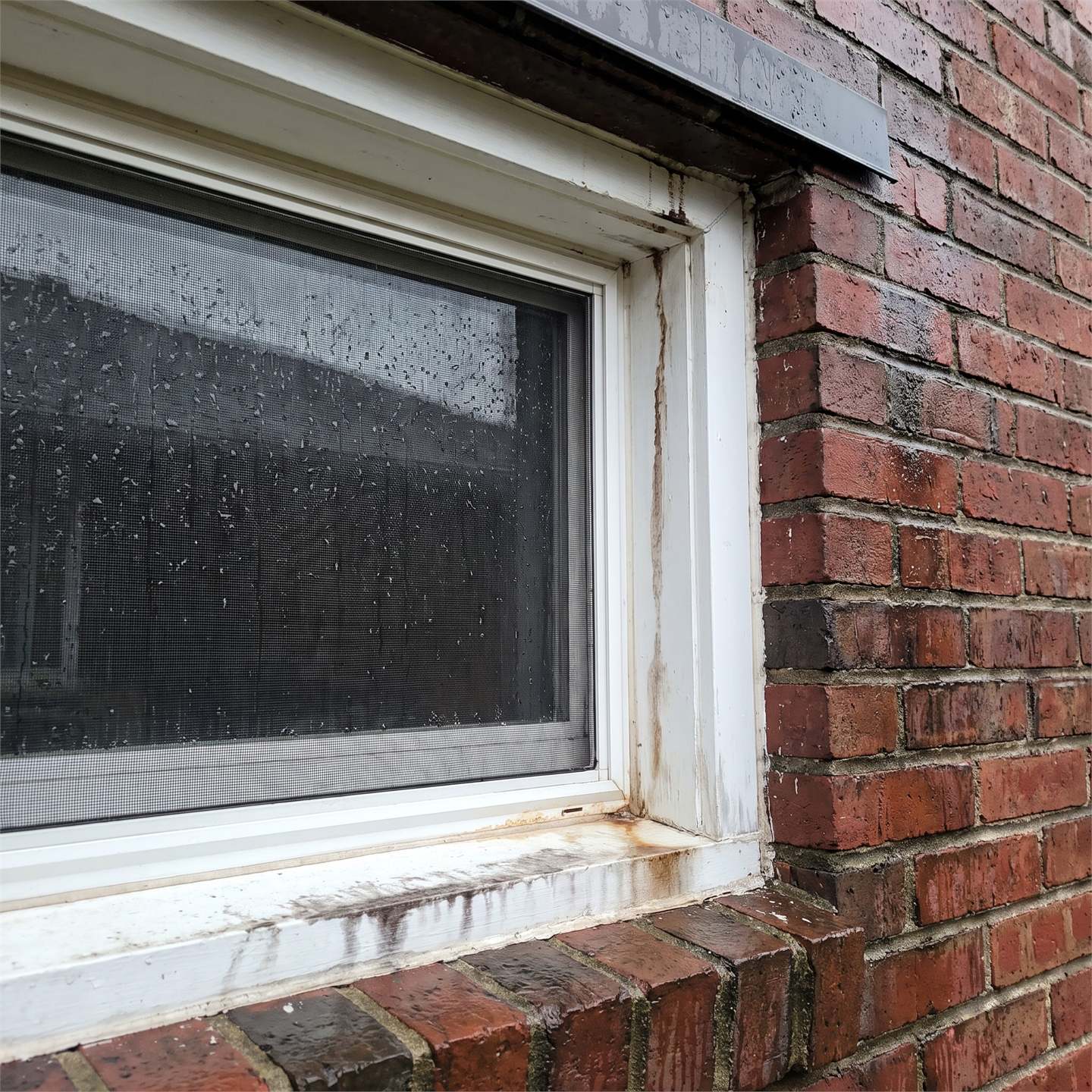 Wind-driven rain around exterior window trim on a residential house after recent storms