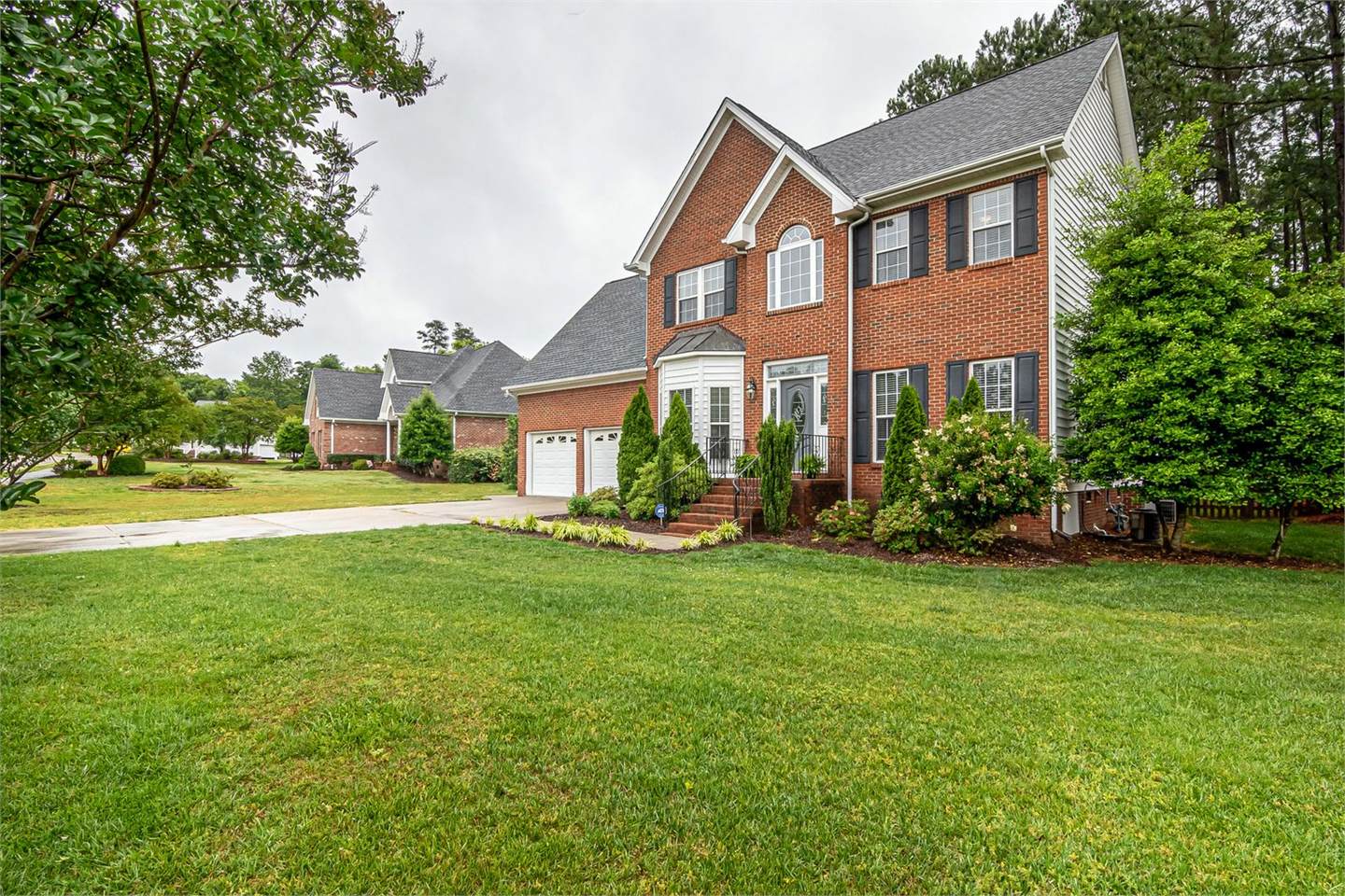 Residential house exterior with brick, siding, shutters, roof edges, soffits, fascia, windows, and trim