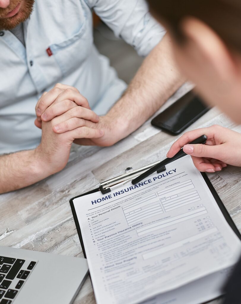 Stock photograph of people reviewing a generic home insurance form. Not Lemonade customers, staff or documents from the Connecticut proceeding.