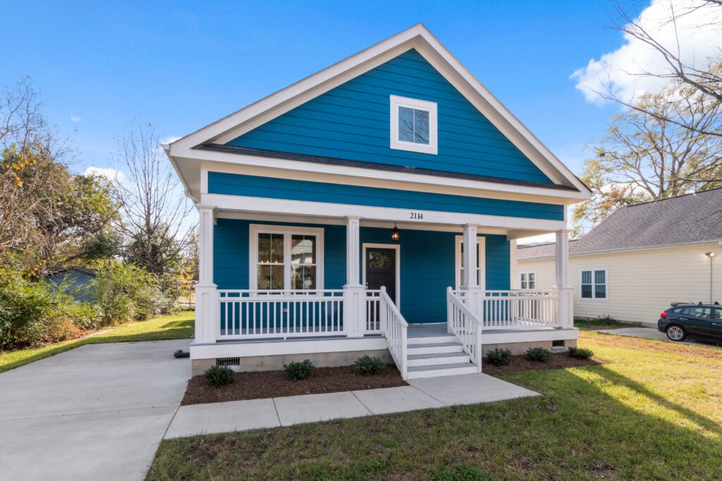 A complete home with blue siding, front porch and gabled shingle roof. Illustrative stock property, not a documented loss.