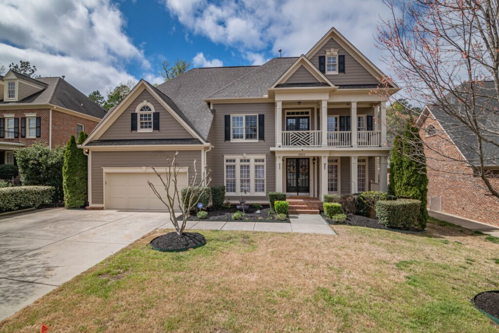A complete suburban home with siding, front porches, shingle roof and garage. Illustrative stock property, not a documented loss.